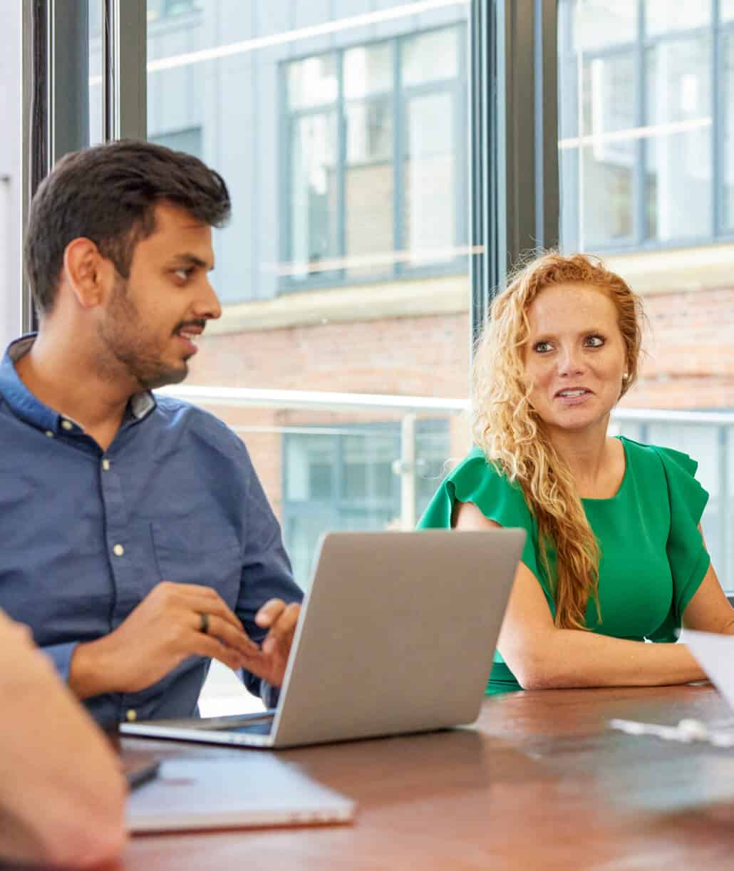 A man and a woman having a casual discussion about business
